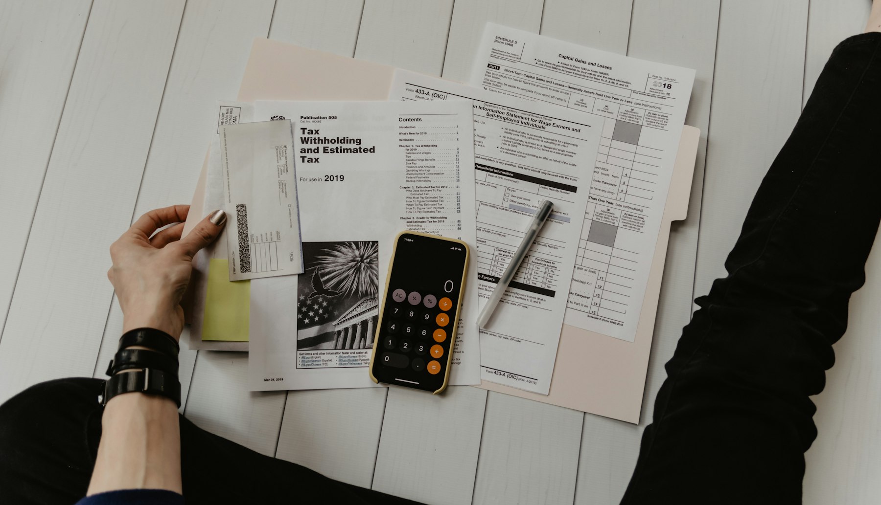 Financial forms, a pen and a calculator on a desk